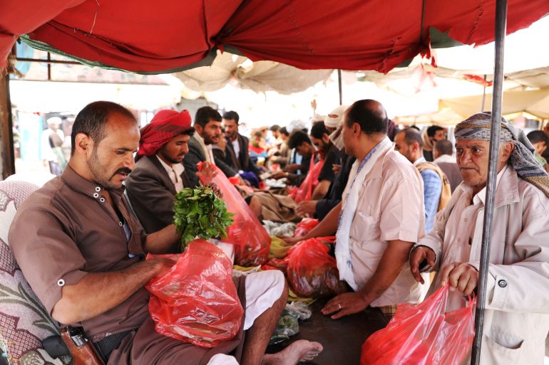 Vendor holds qat, a mild stimulant, at a qat market amid concerns of the spread of the coronavirus disease (COVID-19) in Sanaa