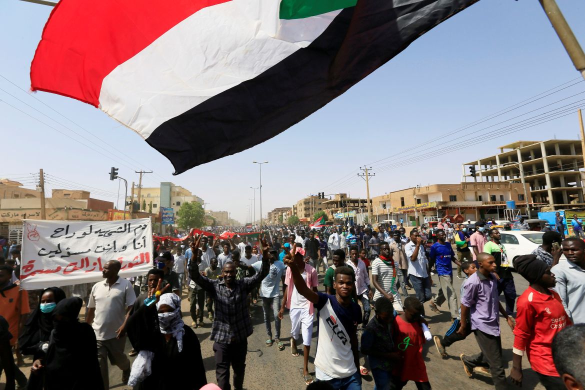 Civilians gather as members of Sudanese pro-democracy protest on the anniversary of a major anti-military protest, as groups loyal to toppled leader Omar al-Bashir plan rival demonstrations in Khartoum