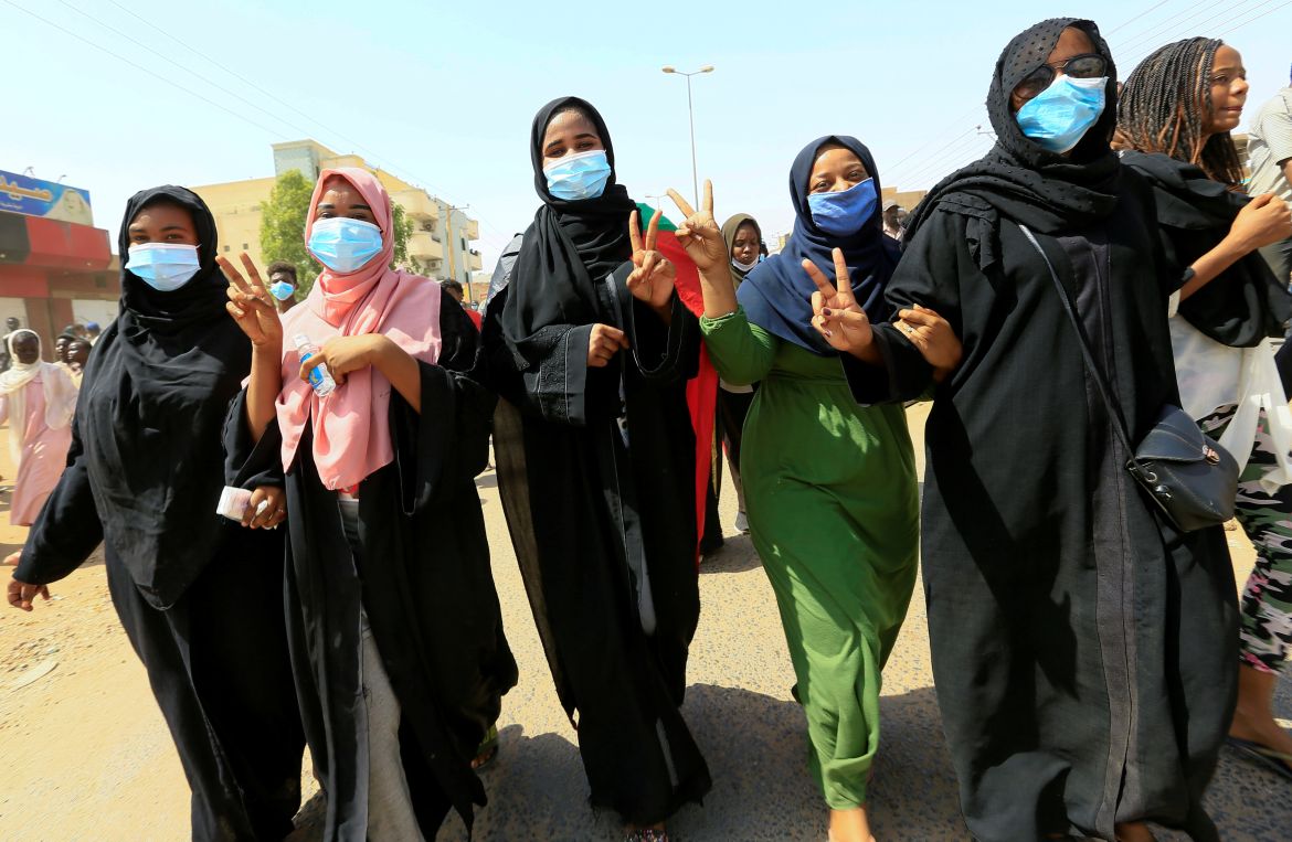 Civilians chant slogans as members of Sudanese pro-democracy protest on the anniversary of a major anti-military protest, as groups loyal to toppled leader Omar al-Bashir plan rival demonstrations in Khartoum
