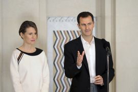 Syria's President Bashar al-Assad stands next to his wife Asma, as he addresses injured soldiers and their mothers during a celebration marking Syrian Mother's Day in Damascus