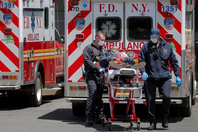 New York City Fire Department (FDNY) EMT's arrive with a patient at St. John's Episcopal Hospital, during the outbreak of the coronavirus disease (COVID-19), in the Far Rockaway section of Queens, New York