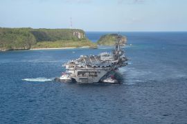 The U.S. Navy aircraft carrier USS Theodore Roosevelt departs following an extended visit in the midst of a coronavirus disease outbreak in Guam