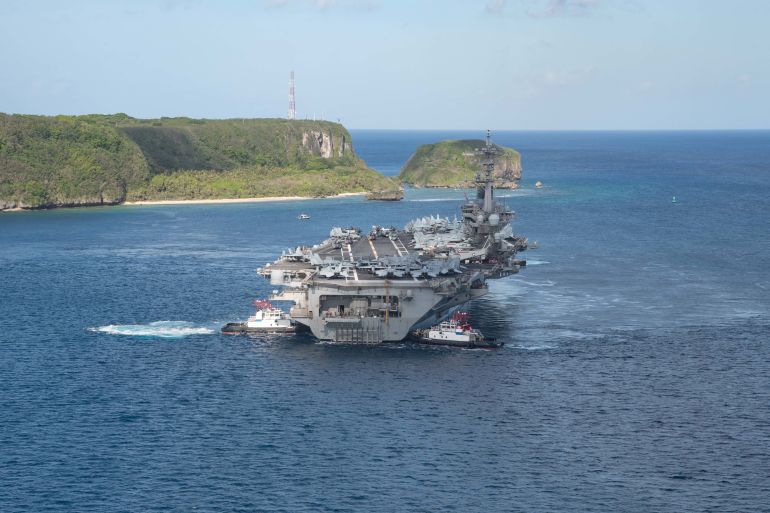 The U.S. Navy aircraft carrier USS Theodore Roosevelt departs following an extended visit in the midst of a coronavirus disease outbreak in Guam