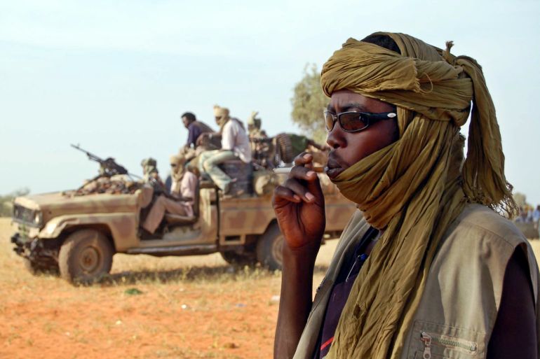 A young guerrilla soldier from Sudan's western Darfur region smokes a cigarette in Kaskanita