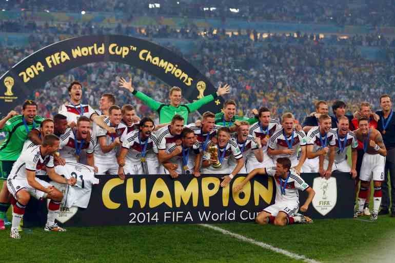 Germany's players pose for pictures as they celebrate with their World Cup trophy after winning their 2014 World Cup final against Argentina at the Maracana stadium in Rio de Janeiro