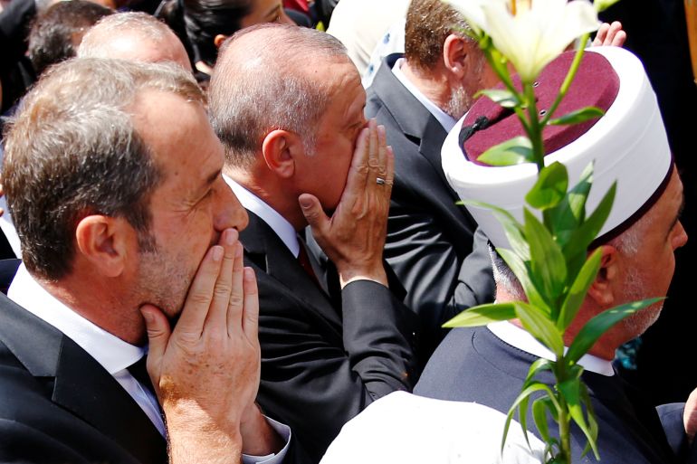Turkey's President Recep Tayyip Erdogan prays at a convoy carrying remains of the Srebrenica genocide victims, in Sarajevo