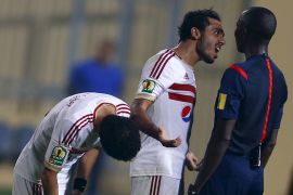 Kahraba of Egypt's Zamalek argues with Gambian referee Gassama after the end of their Confederation Cup semi-final soccer match against Tunisia's Etoile du Sahel at Petro Sport stadium in Cairo