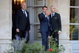 French President Emmanuel Macron and Tunisian President Kais Saied arrive for a joint news conference after their meeting at the Elysee Palace in Paris