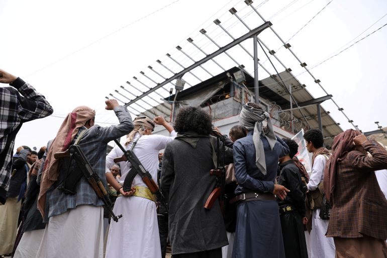 Armed Houthis gather outside the United Nations offices to denounce the Saudi-led coalition's blockade, in Sanaa