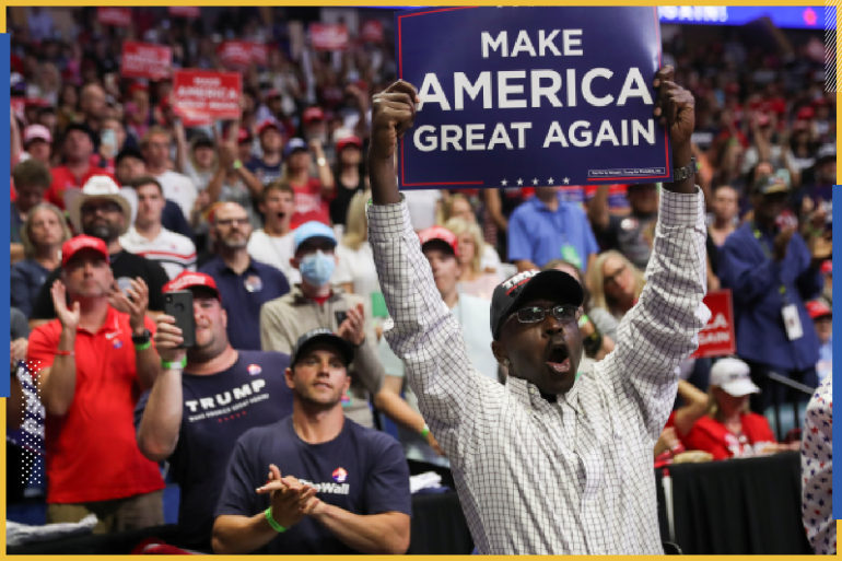 A Black supporter of U.S. President Donald Trump holds up a "Make America Great Again" sign as the president arrives at his first re-election campaign rally in several months in the midst of the coronavirus disease (COVID-19) outbreak, at the BOK Center in Tulsa, Oklahoma, U.S., June 20, 2020. REUTERS/Leah Millis