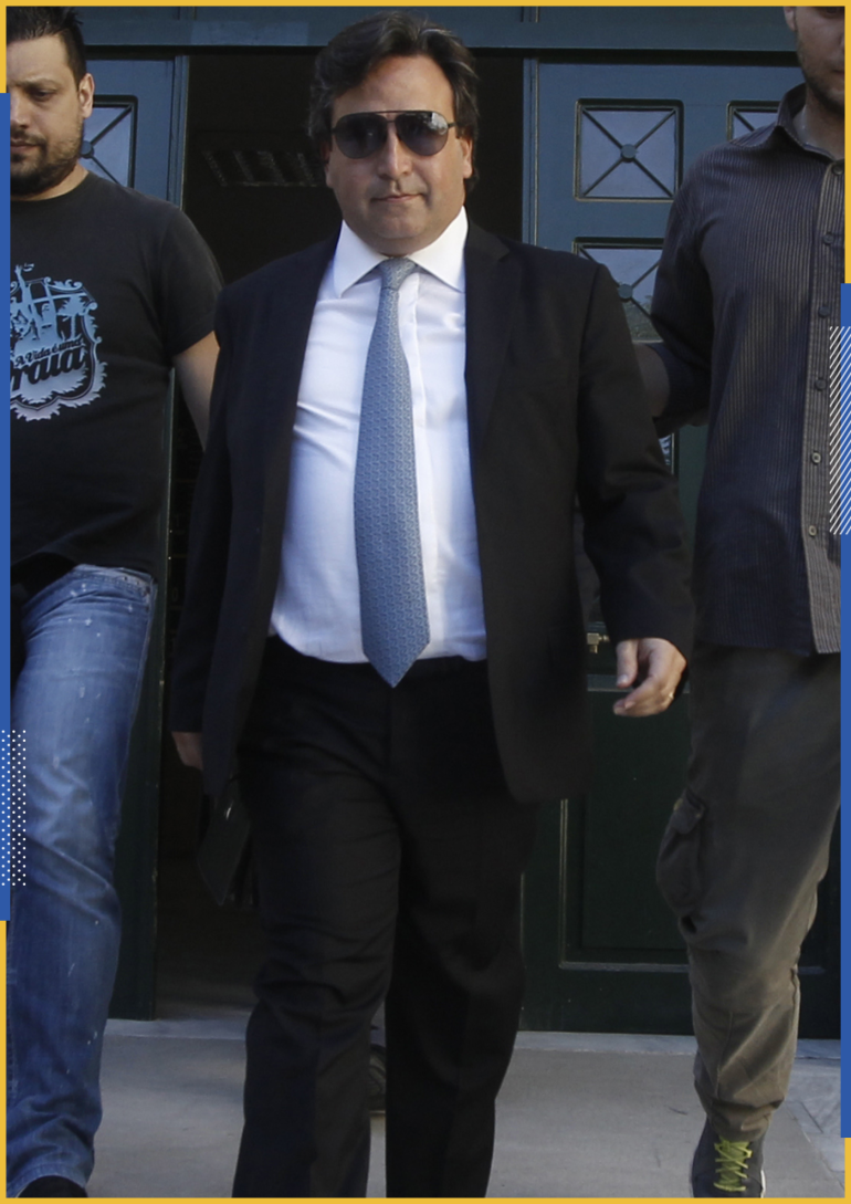 Greek shipowner Victor Restis (2nd R) is escorted by plainclothes policemen as he leaves a court in Athens July 23, 2013. Restis was arrested on Tuesday on suspicion of money laundering and embezzlement, police and court officials said, becoming one of just a few prominent businessmen to be arrested since Greece sank into crisis. REUTERS/John Kolesidis (GREECE - Tags: BUSINESS CRIME LAW MARITIME)