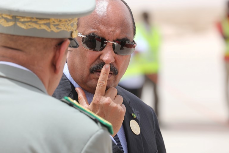 Mauritania's President Mohamed Ould Abdel Aziz waits for the arrival of the French President at Nouakchott airport