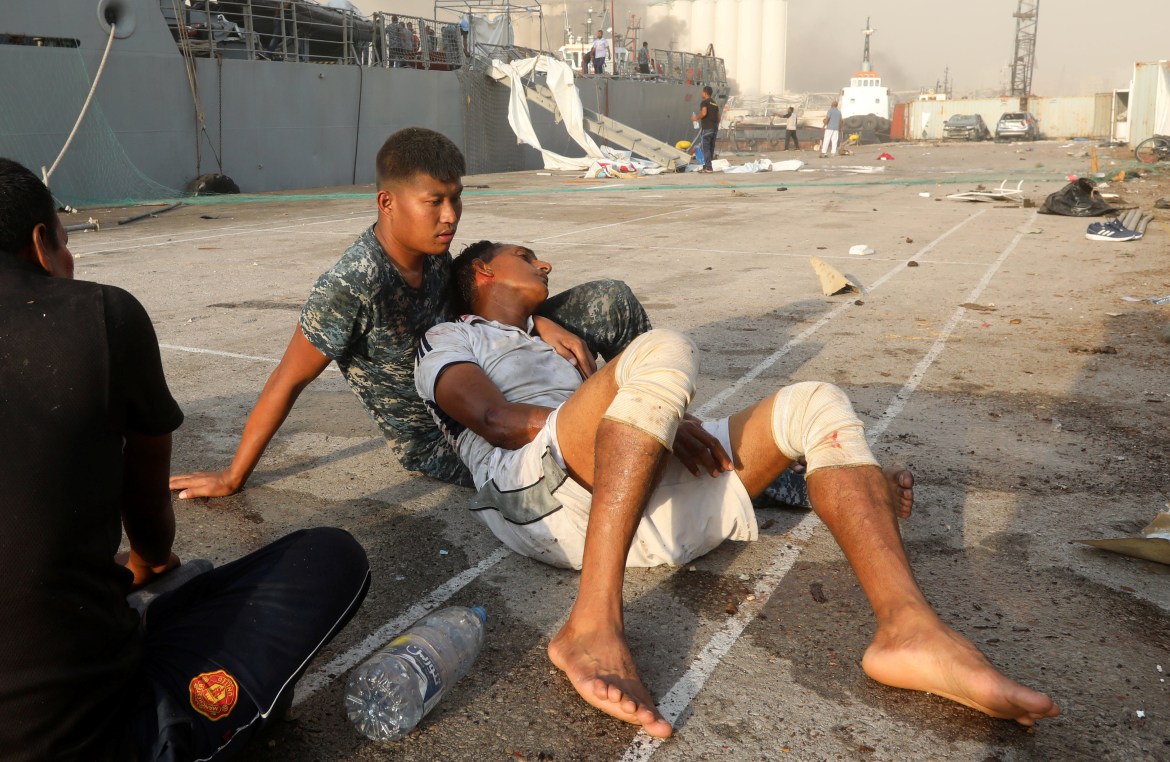 SENSITIVE MATERIAL. THIS IMAGE MAY OFFEND OR DISTURB. An injured man is seen following an explosion in Beirut