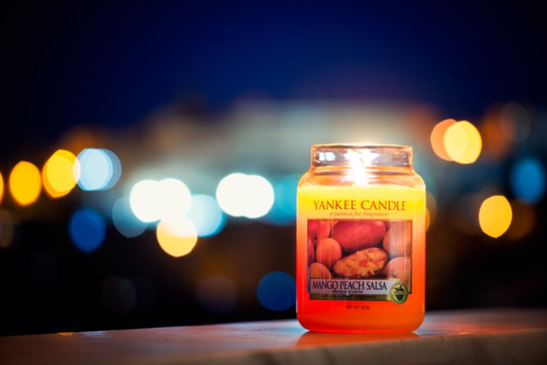 Cagliari, Italy 10/07/2018; Yankee candle big jar at night with lights bokeh in background ; Shutterstock ID 1131374114; Department: -