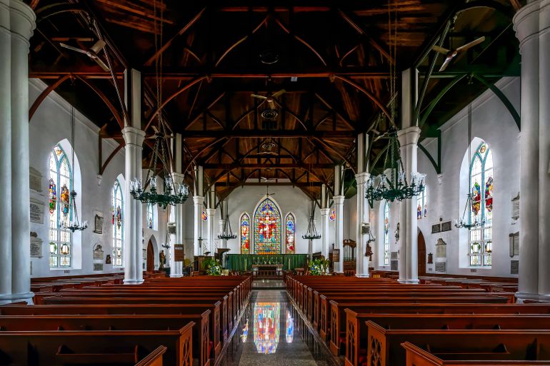 NASSAU, BAHAMAS-September 10, 2018:The interior of the Christ Church Cathedral of Nassau in the Bahamas, built in 1841, features beautiful mahogany pews completed in 1995; Shutterstock ID 1215874939; Department: -