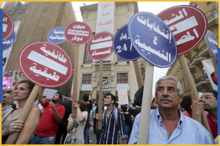 Protesters carry anti-govenment signs during a protest against perceived government failures, including a rubbish disposal crisis, at Martyrs' Square in downtown Beirut, Lebanon September 9, 2015. Lebanese security services locked down central Beirut on Wednesday as ministers and parliamentarians met to discuss ways out of a political crisis that has paralysed government and fueled a wave of street protests. REUTERS/Hasan Shaaban TPX IMAGES OF THE DAY