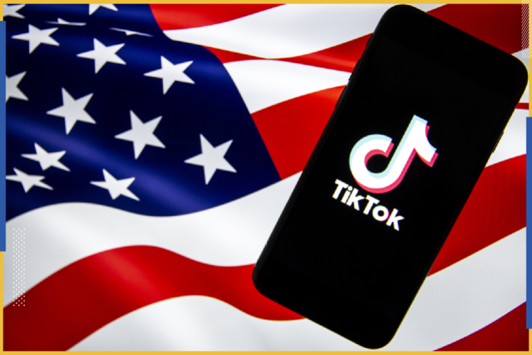 TikTok - WeChat- - ANKARA, TURKEY - AUGUST 7: The logo of "TikTok" is displayed on a smartphone as the U.S. flag is seen at the background in Ankara, Turkey on August 7, 2020. President Donald Trump signed two executive orders Thursday banning any transactions by US residents and companies with Chinese-owned social media apps TikTok and WeChat beginning Sept. 20.