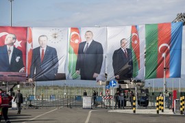 epa08034879 Portraits of Mustafa Kemal Ataturk (L), founder of modern Turkey; Turkish President Recep Tayyip Erdogan (2-L) and Azerbaijan's President Ilham Aliyev (C) hang over a check point during the opening ceremony of the Trans-Anatolian...