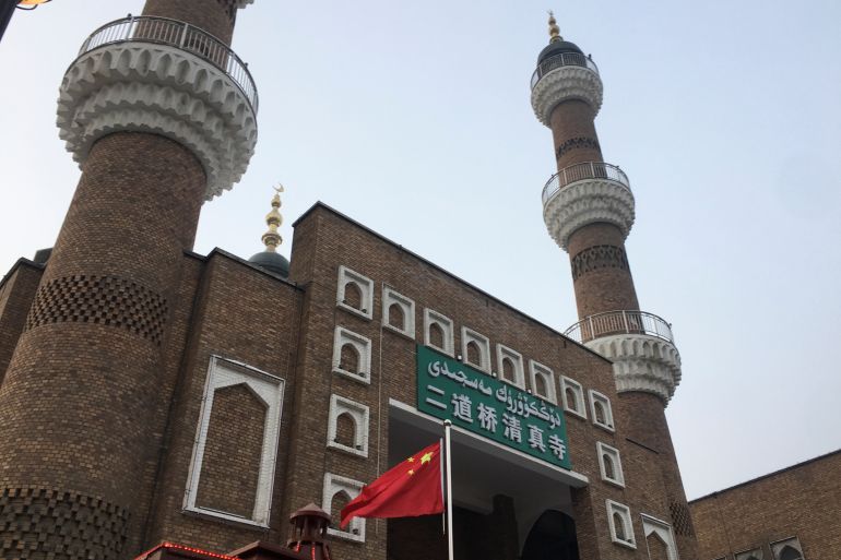 The Chinese national flag flies outside the mosque at the Xinjiang International Grand Bazar during a government organised trip in Urumqi