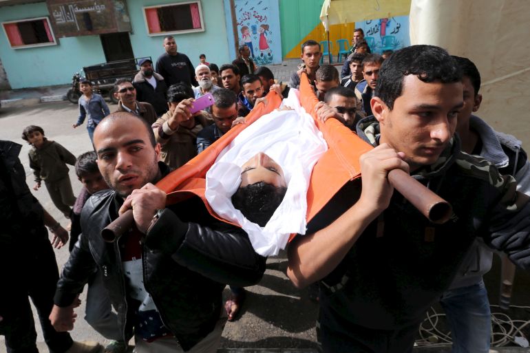 Palestinians carry the body of Feras Meqdad, who health officials said was shot dead by Egyptian forces, during his funeral in Rafah in the southern Gaza Strip