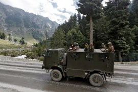 Indian army soldiers are seen atop a vehicle on a highway leading to Ladakh, at Gagangeer