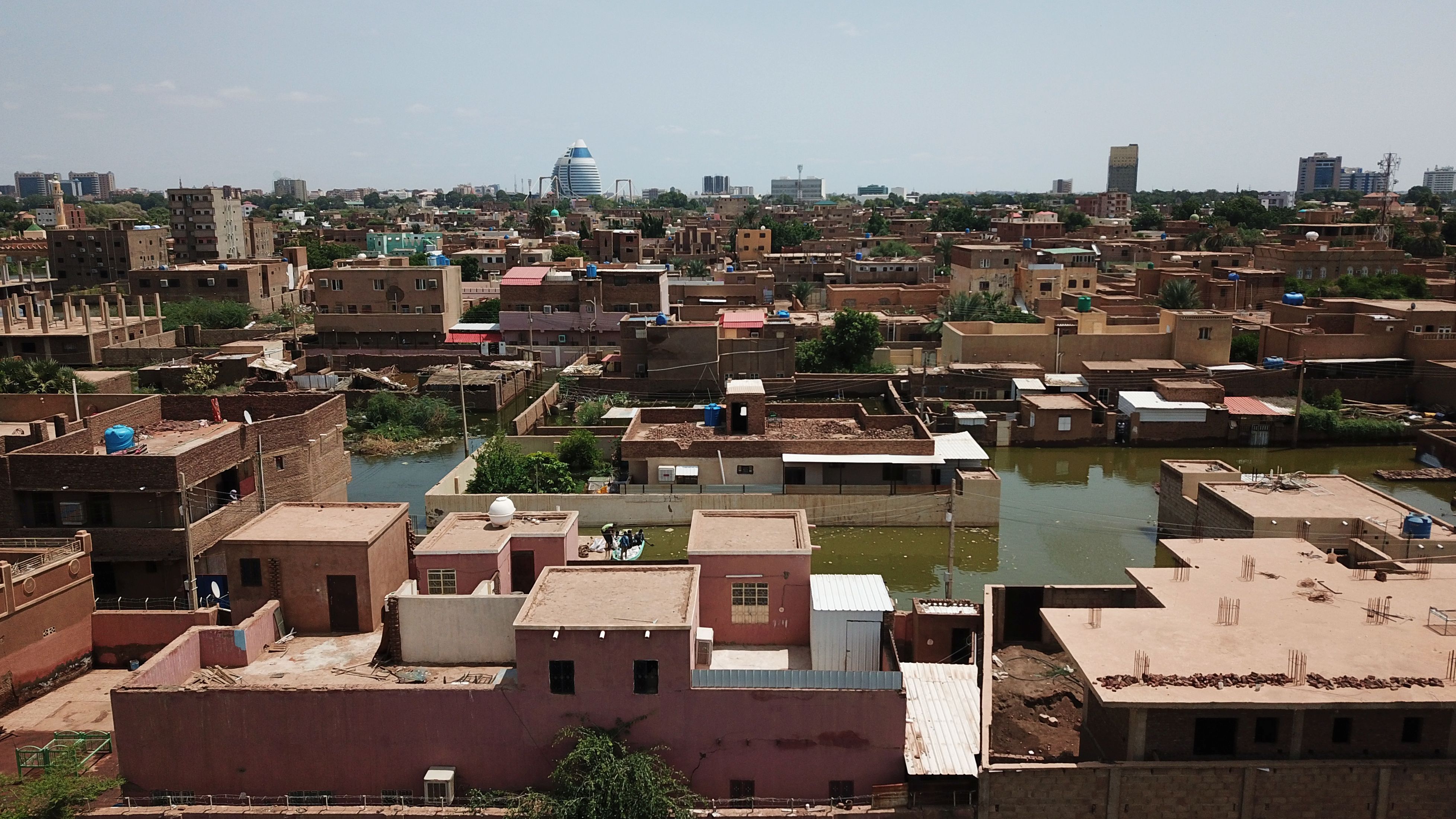 An aerial view shows buildings and roads submerged by floodwaters near the Nile River in South Khartoum