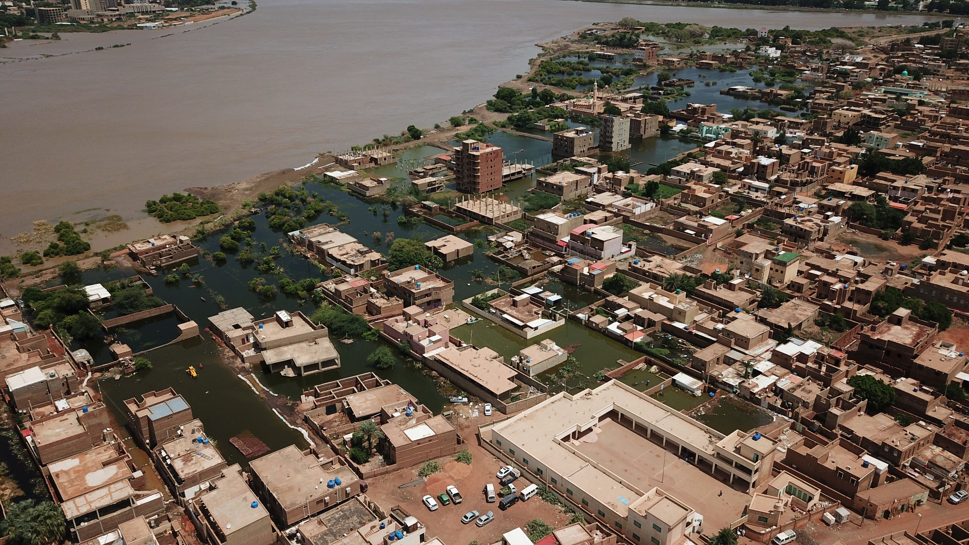 An aerial view shows buildings and roads submerged by floodwaters near the Nile River in South Khartoum