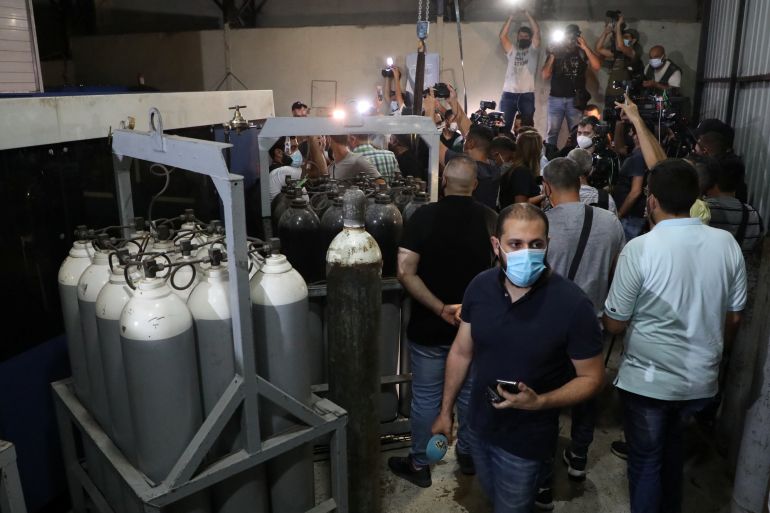 Journalists are seen inside a building during a Hezbollah guided tour in the Jnah neighborhood of Beirut