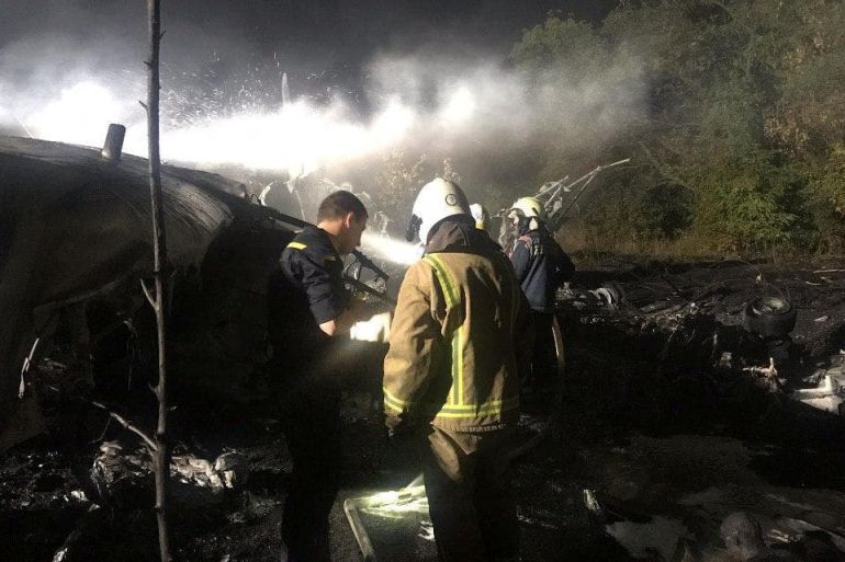 Rescuers work at the crash site of the Ukrainian military Antonov An-26 plane outside of Chuhuiv town, Ukraine September 25, 2020. State Emergency Service of Ukraine/Handout via REUTERS ATTENTION EDITORS - THIS IMAGE WAS PROVIDED BY A THIRD PARTY.