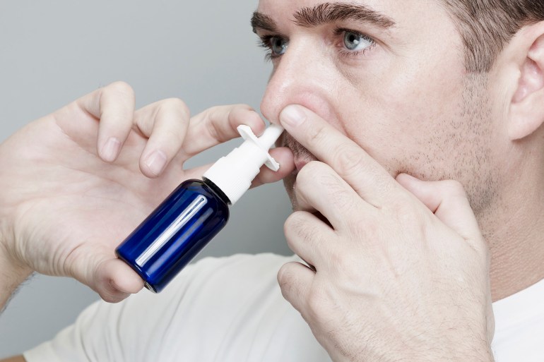 Man Using Nasal Spray Inhaler.