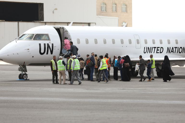 People board a United Nations plane which will carry them to Amman, Jordan in the first flight of a medical air bridge from Sanaa airport in Sanaa, Yemen