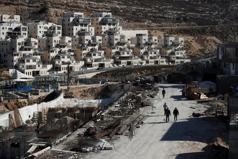 Labourers work in a construction site in the Israeli settlement of Ramat Givat Zeev in the occupied-West Bank