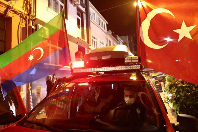 Members of Turkey's IHH display Turkish and Azerbaijan flags on their vehicle before taking a tour in the city in solidarity with Azerbaijan, in Istanbul