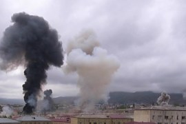 Smoke billows above buildings during a military conflict over Nagorno-Karabakh, in Stepanakert