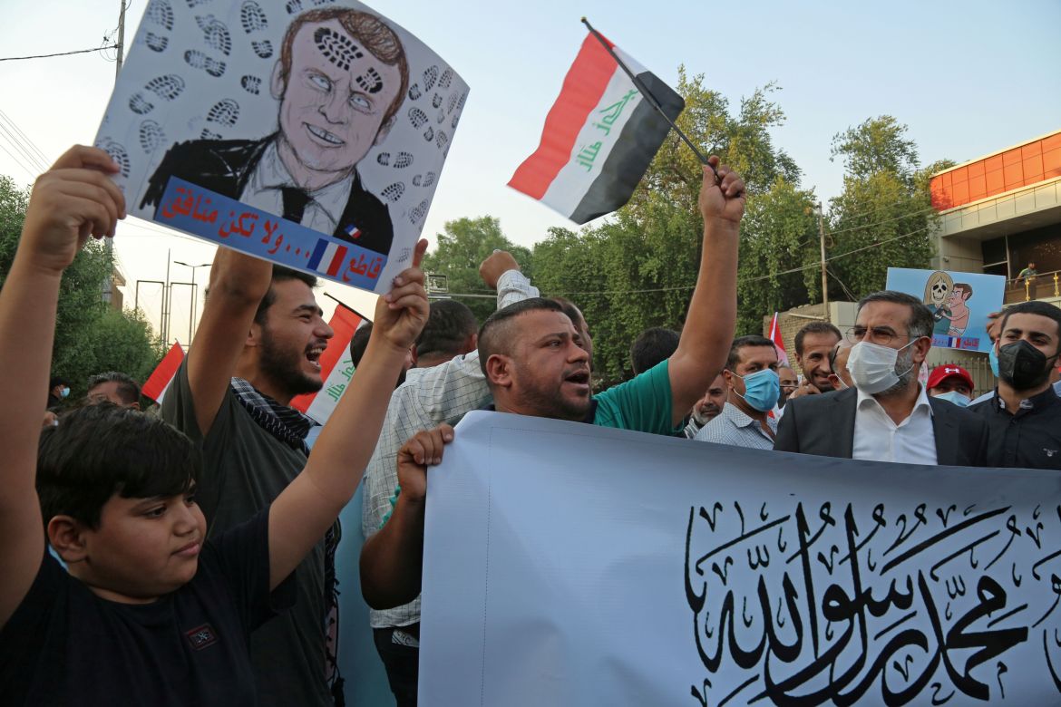 Iraqi people shout slogans during a protest against the publications of a cartoon of Prophet Mohammad in France and French President Emmanuel Macron's comments, outside the French embassy in Baghdad