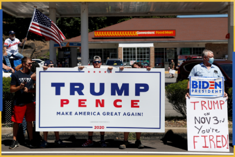 A man holds a sign in support of Democratic presidential nominee Joe Biden as supporters of U.S. President Donald Trump gather ahead of his campaign stop in Old Forge, Pennsylvania, U.S., August 20, 2020. REUTERS/Shannon Stapleton TPX IMAGES OF THE DAY