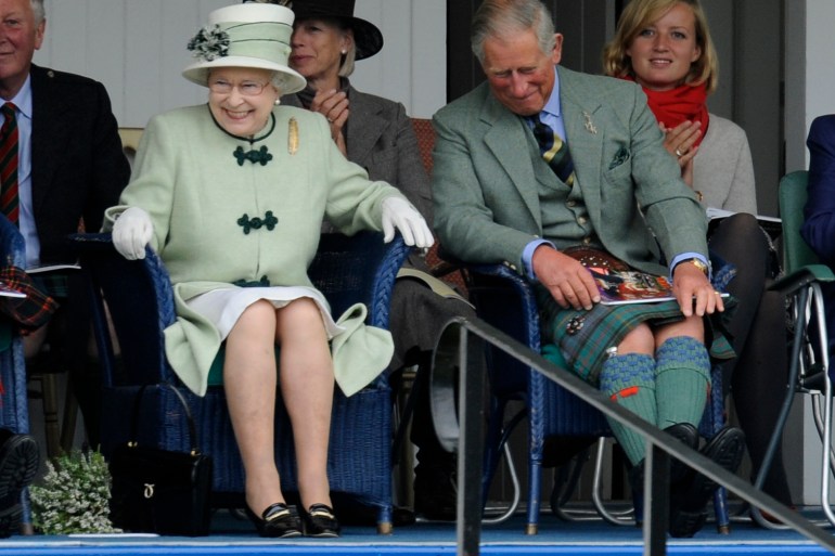 Britain's Queen Elizabeth and Prince Charles attend the Braemar Gathering, in Braemar Scotland
