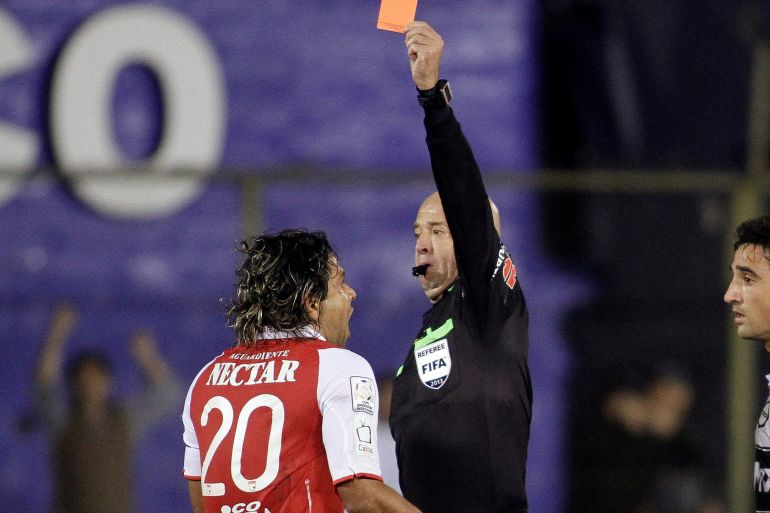 Colombia's Independiente Santa Fe player Bedoya receives red card by referee Lopes during their first semi final match of the Copa Libertadores in Asuncion Colombia's Independiente Santa Fe player Gerardo Bedoya (L) receives a red card by referee Heber Lopes during their first semi final match of the Copa Libertadores in Asuncion, July 2, 2013. REUTERS/Mario Valdez (PARAGUAY - Tags: SPORT SOCCER)