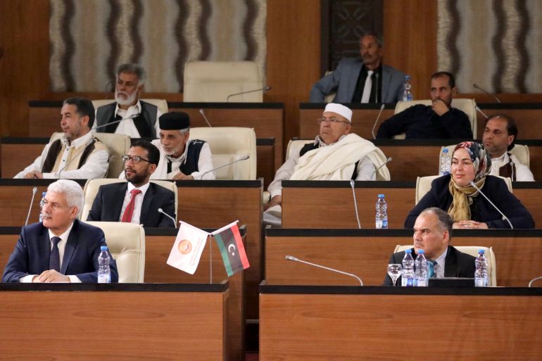 Lawmakers allied to Libya's internationally recognized government attend their first session at the parliament headquarters in Tripoli