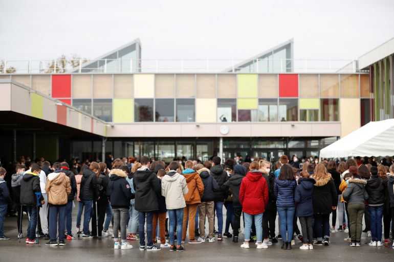 A teacher and schoolchildren pay tribute to French teacher Samuel Paty in France