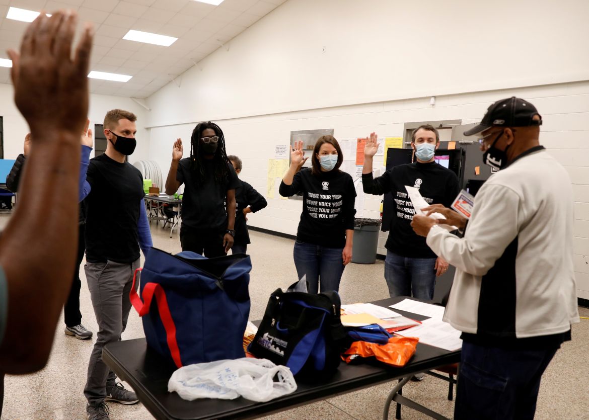 Poll workers take an oath at Fulton County polling station during the election in Atlanta