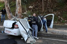 Members of the Lebanese police inspect the damaged car in Hadath, Lebanon, November 21, 2020. REUTERS/Mohamed Azakir