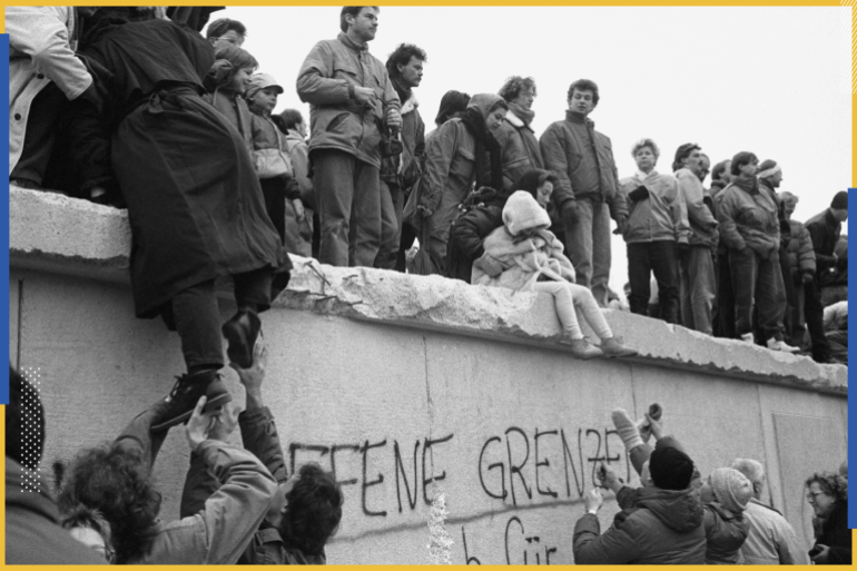East Berliners climb onto the Berlin Wall to celebrate the effective end of the city's partition, 31st December 1989. (Photo by Steve Eason/Hulton Archive/Getty Images)