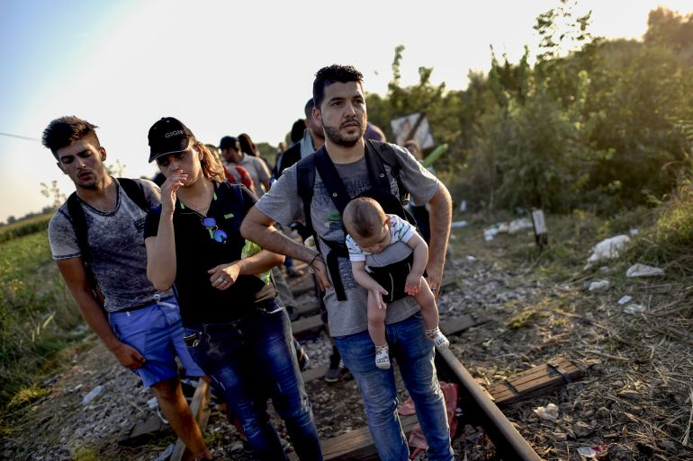 This combination of photographs created on December 15, 2020, shows (TOP): Iraqi refugees Ahmad (R) and Alia with their then four month old baby Adam as they walk on a railway line at the Serbian-Hungarian border at Horgos on September 1, 2015, and (BOTTOM): Ahmad (R) with his wife Alia (L) and their five year old son Adam sit at a coffee shop in the city of Arnhem, The Netherlands on September 23, 2020.
