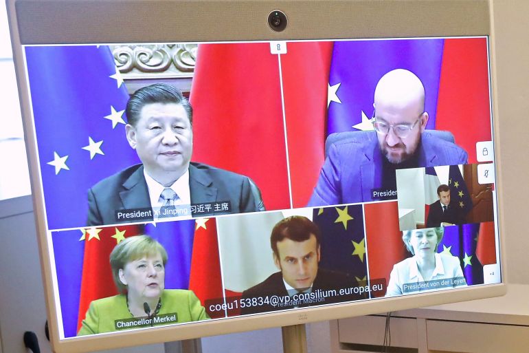 epa08911227 French President Emmanuel Macron (R) attends a EU-China video-conference meeting along with Chinese President Xi Jinping, German Chancellor Angela Merkel, European Commission President Ursula von der Leyen and President of the European...