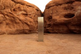 A metal monolith is seen in Red Rock Desert, Utah