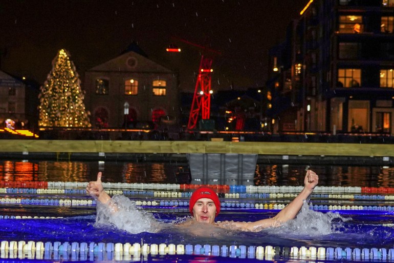 Man shows thumbs up while swimming during a largest winter swimming relay in Tallinn, Estonia, December 11, 2020. Picture taken December 11, 2020. REUTERS/Janis Laizans