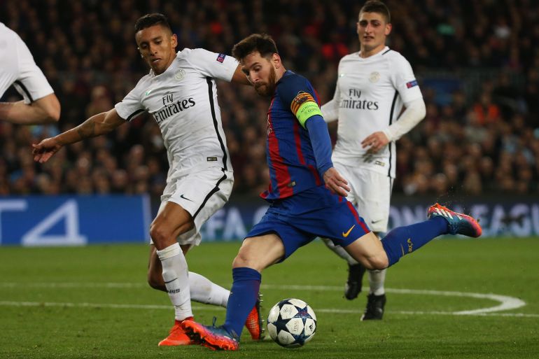 Paris Saint-Germain's Marquinhos in action with Barcelona's Lionel Messi