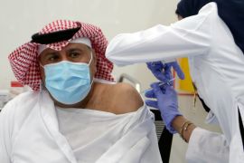 A Saudi man gets a dose of a coronavirus disease (COVID-19) vaccine, in Riyadh