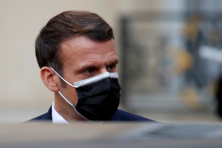 French President Emmanuel Macron, wearing a protective face mask, accompanies Egyptian President Abdel Fattah al-Sisi (not seen)after a meeting at the Elysee Palace in Paris during his official visit to France, December 7, 2020. REUTERS/Gonzalo Fuentes